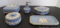 View of all five Wedgwood jasperware items including trinket boxes, perfume holder, soap dish arranged on flat surface