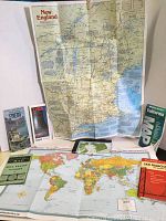 Overview of the map collection showing various fold-out and booklet style maps including New England, world, USA regions, and Mill Valley California maps
