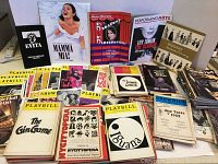 Wide assortment of over 130 Playbills and theater programs showing colorful covers including Evita, Mamma Mia!, Deadwood, and older classic programs.