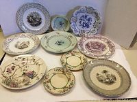 Overview of ten assorted antique plates showing variety in size, style, and decoration.