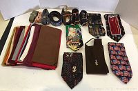 Photo showing the assortment of belts on top, novelty ties below, and folded pocket squares on the right side