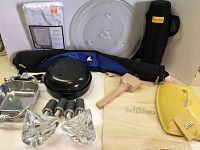 Full lot contents featuring assorted household kitchen and decorative items including crystal candle holders, casserole lid, padded bag, mallet, metal pot, canvas bag, and square silver-tone dishes.