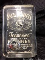 Front view of the paperweight showing the Jack Daniels logo and embedded dice compartment.