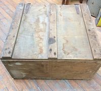 Top view of the vintage solid wood trunk showing the wide slats on the lid, wear marks, and slight discoloration.