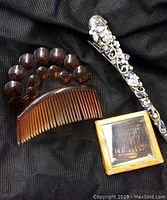 Four vintage hair accessory pieces displayed on black fabric background, showing all items together.