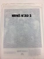 Photo of translucent folder labeled Wayne's World 2 containing promotional photos