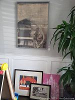 Large framed monochrome canvas art on wall, abstract industrial design, photographed with plant near edge