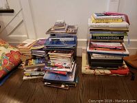 Three stacks of books on floor showing entire lot