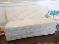 Front view of fabric covered bench showing clean patterned light-colored fabric with cushioned seat and backrest.