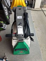 Full front and top view showing handle, power cord wrapped on holders, relief valve, dual tanks