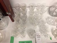 Top view of 27 lead-crystal Webb Corbett glasses arranged including wine glasses and goblets with cut designs.
