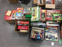 Overview of assorted games, puzzles, educational toys including Rubik's Cube, flash cards, counting sticks in boxes and packages.