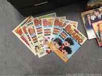Photo showing multiple vintage Beano comics stacked showing colorful cartoon covers