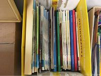 Top view of the lot showing a row of Christian books of different sizes and thicknesses, mainly softcover, some colorful, some thicker with Bible themes.
