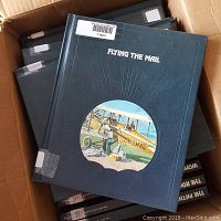 Box of blue hardcover Time Life books with 'Flying the Mail' title visible on the cover.