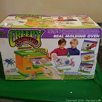 Photo of the original Creepy Crawlers Real Molding Oven box showing the oven and children using the set.