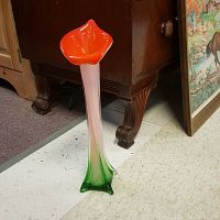 Full view of the colorful handblown glass vase showing orange flared top extending down to pink midsection and green base.