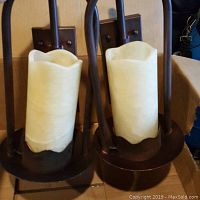 Two custom ordered electric wall sconces with dark metal finish and off-white stone faux candle globes.