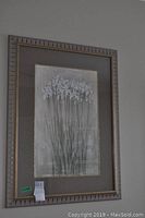 Large floral print featuring white flowers on a textured beige background with a light brown ornate frame.