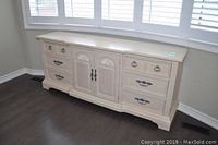 Front view of Stanley dresser showing 6 drawers and central doors with metal pulls