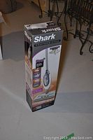 Side view of boxed Shark Professional Pro Steam Pocket Mop showing product picture and features.