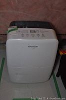 Front view of white Garrison dehumidifier showing brand logo and front design.
