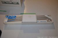 Photo of boxed Bond Classic knitting machine, showing full length of the compact box with product label visible.