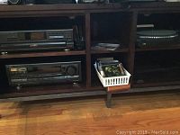 Wide shot of all three units placed on shelving, along with CDs that are not included.