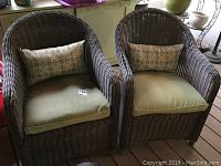 Two wicker chairs side by side showing overall condition, cushions, and pillows.