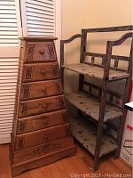 Photo showing the pyramid-shaped chest of drawers next to the 3-tier shelf unit against a wall.