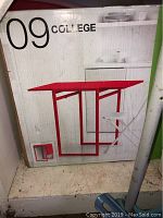 Box front showing red folding leaf table with metal frame and melamine laminate top, brand labeled as '09 College'