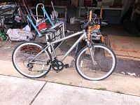 Side profile of the Schwinn Trailway 10-speed bicycle showing silver frame, white sidewall tires, drivetrain and saddle.