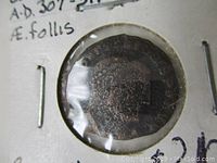 Close-up image of obverse side of Roman coin showing Emperor Constantine I portrait, in holder with handwritten label.
