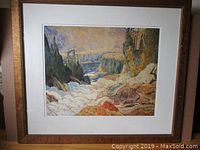 Front view of large framed lithograph in wood frame under glass showing detailed view of landscape artwork.