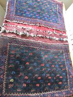 Front view of the black wool rug showing colorful small motifs and patterned border.