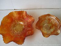 Photo showing two carnival glass dishes side by side, highlighting size difference and shape