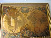 Full front view of framed gold foil double hemisphere world map print by Henricus Hondius.