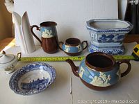 Photo showing all ceramic pieces: Royal Dalton vase, Gibsons jug set, Johnsons bowl, West Germany sugar dish, Chinese planter with measuring tape noting planter size.