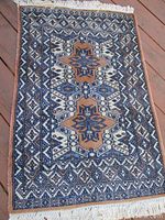 Overhead full view on wooden deck showing overall pattern, colors, and condition