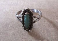 Top angle view showing turquoise stone and beaded silver frame