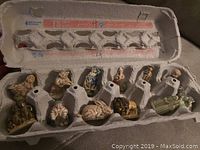 All 12 porcelain figurines stored in an egg carton for protection and transport.