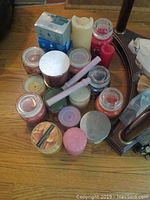 Overview of assorted candles including jar, pillar, votive types, various colors and sizes