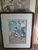 Full view of male figure print in black frame with white mat.