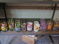 Image showing 12 various vintage drinking glasses including McDonald glasses with Peanuts characters, Budweiser, Sea World and others.