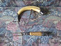 Photo shows a curved horn handled wine cork opener with sterling silver caps and a metal corkscrew, and a two-pronged meat fork with a handle of horn/antler and sterling silver fittings on each end.