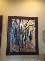 Large abstract forest themed framed painting showing dark tree trunks and white flowers with warm background.
