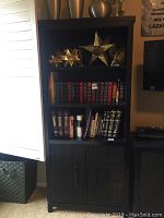 Full view of the bookcase filled with decorative items and books, showing size and style