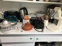 Kitchen counter view showing all appliances in the lot including juicer, toasters, rice cooker, mixer base, and George Foreman grill lid and body