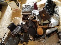 Group shot of assorted women's purses in cardboard box