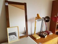 Large wood framed mirror, small gold-tone mirror, and three desk lamps on table